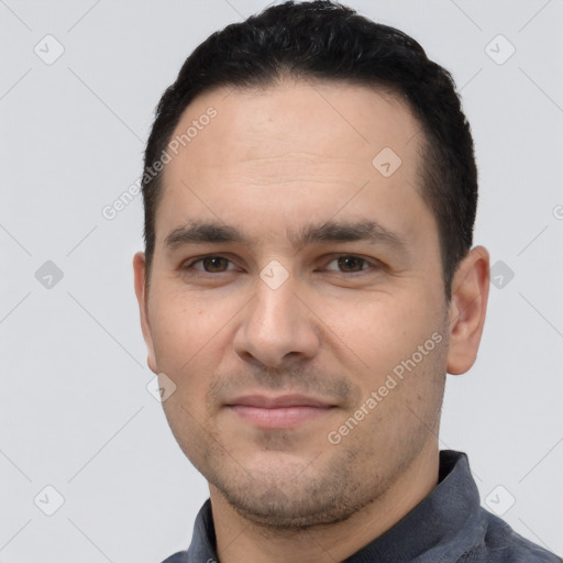 Joyful white young-adult male with short  black hair and brown eyes