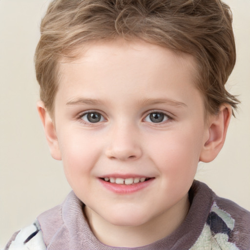 Joyful white child male with short  brown hair and grey eyes