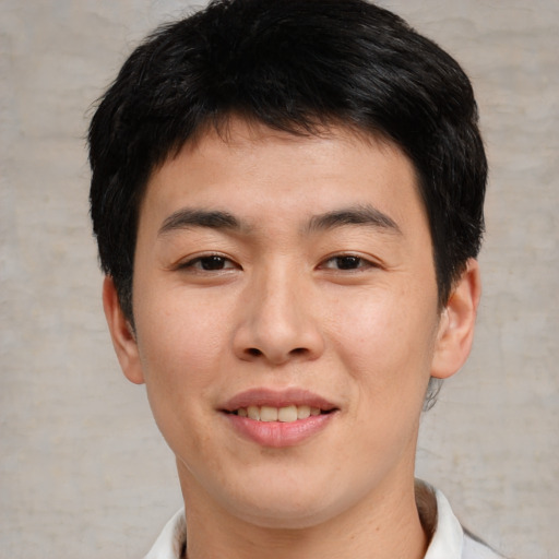 Joyful asian young-adult male with short  brown hair and brown eyes