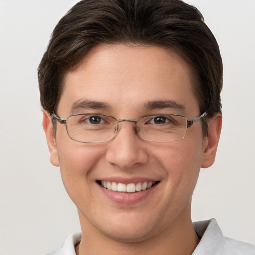 Joyful white young-adult male with short  brown hair and grey eyes