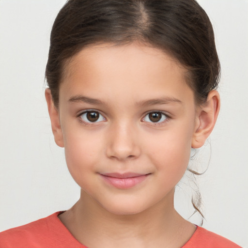 Joyful white child female with short  brown hair and brown eyes