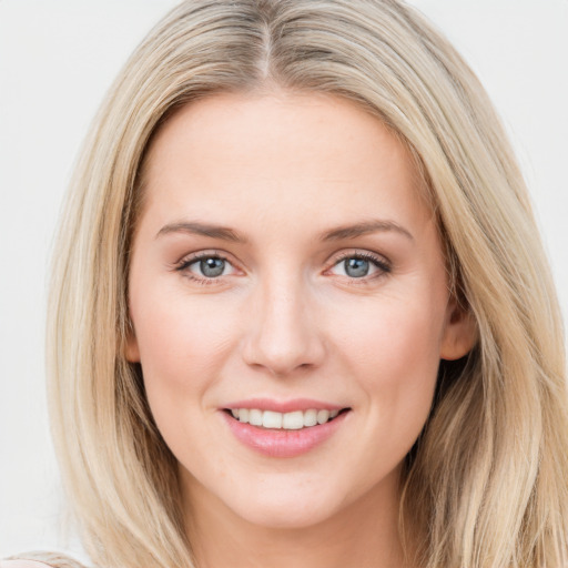 Joyful white young-adult female with long  brown hair and blue eyes