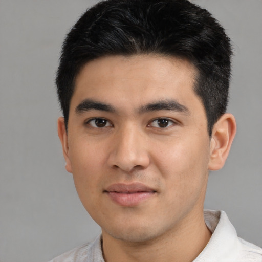 Joyful asian young-adult male with short  black hair and brown eyes