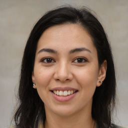 Joyful latino young-adult female with long  brown hair and brown eyes