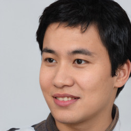 Joyful asian young-adult male with short  black hair and brown eyes