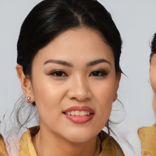 Joyful asian young-adult female with medium  brown hair and brown eyes