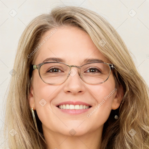 Joyful white adult female with long  brown hair and blue eyes