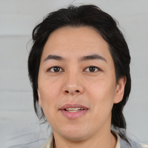 Joyful asian adult male with medium  brown hair and brown eyes