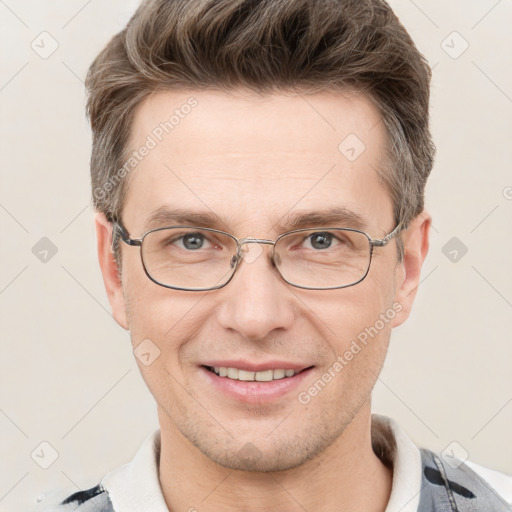 Joyful white adult male with short  brown hair and grey eyes