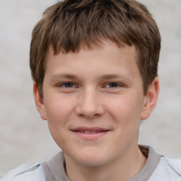 Joyful white child male with short  brown hair and brown eyes