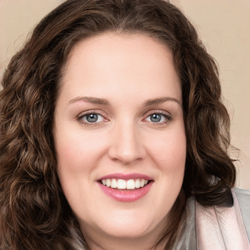 Joyful white young-adult female with long  brown hair and green eyes