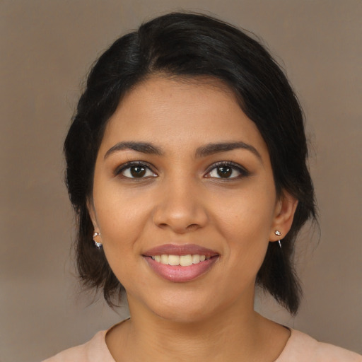 Joyful latino young-adult female with medium  brown hair and brown eyes