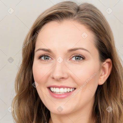 Joyful white young-adult female with long  brown hair and blue eyes