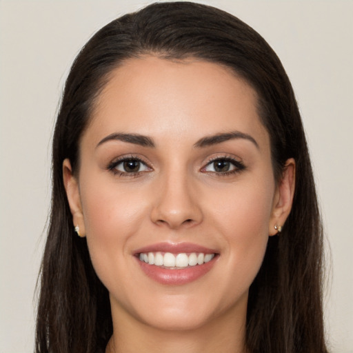 Joyful white young-adult female with long  brown hair and brown eyes