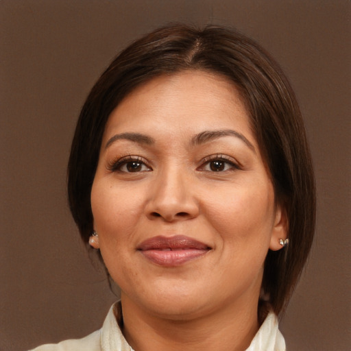 Joyful white adult female with medium  brown hair and brown eyes