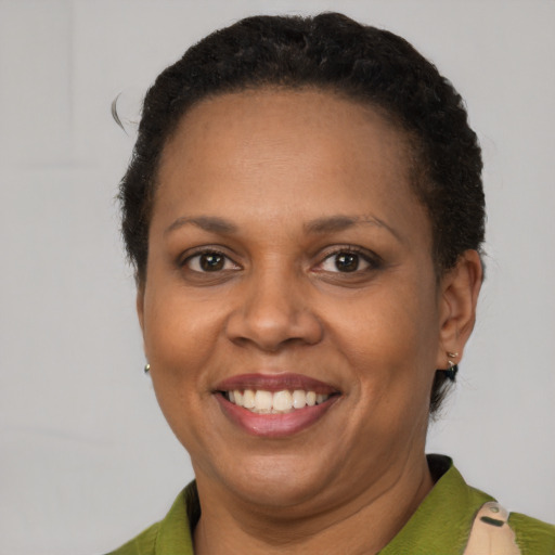 Joyful latino adult female with short  brown hair and brown eyes