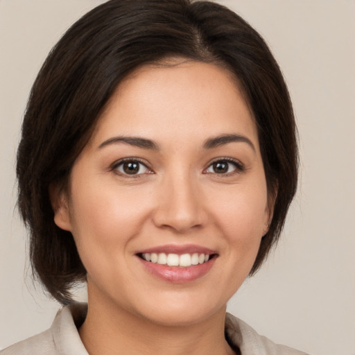 Joyful white young-adult female with medium  brown hair and brown eyes