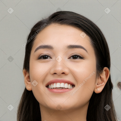 Joyful white young-adult female with long  black hair and brown eyes