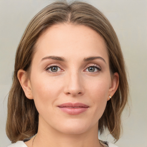 Joyful white young-adult female with medium  brown hair and green eyes