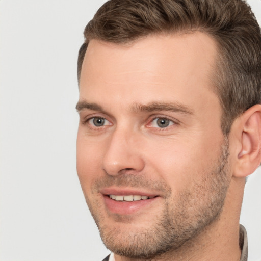 Joyful white young-adult male with short  brown hair and brown eyes