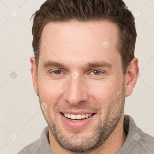 Joyful white adult male with short  brown hair and brown eyes