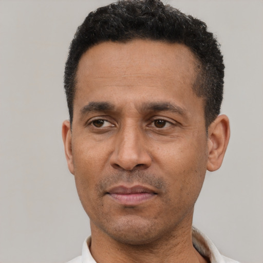 Neutral latino adult male with short  black hair and brown eyes