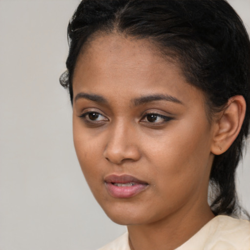 Neutral black young-adult female with medium  black hair and brown eyes