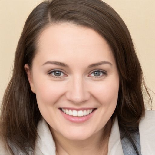 Joyful white young-adult female with long  brown hair and brown eyes