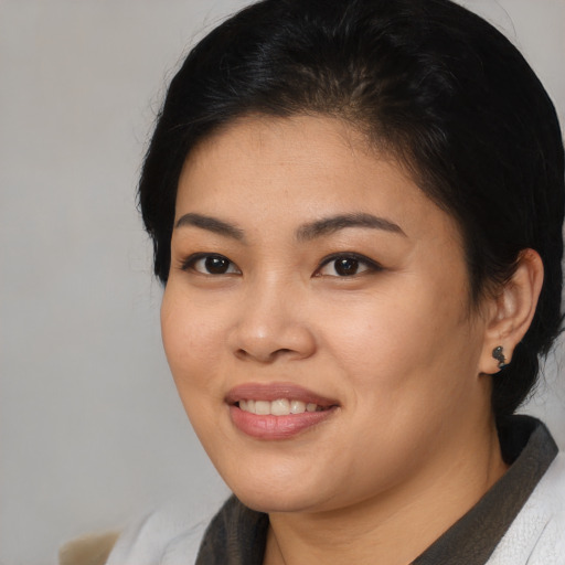 Joyful asian young-adult female with medium  black hair and brown eyes