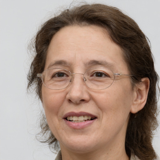 Joyful white middle-aged female with medium  brown hair and grey eyes