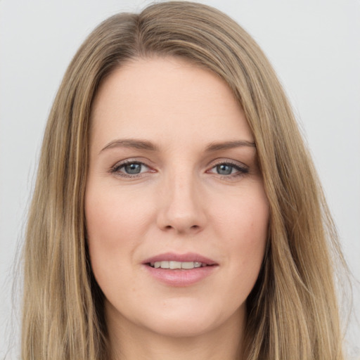 Joyful white young-adult female with long  brown hair and green eyes