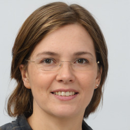 Joyful white young-adult female with medium  brown hair and grey eyes