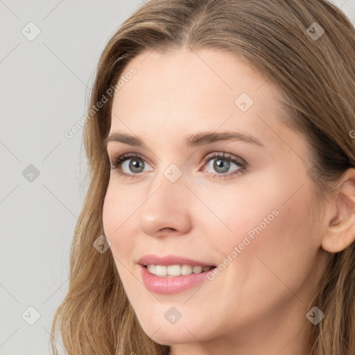 Joyful white young-adult female with long  brown hair and blue eyes