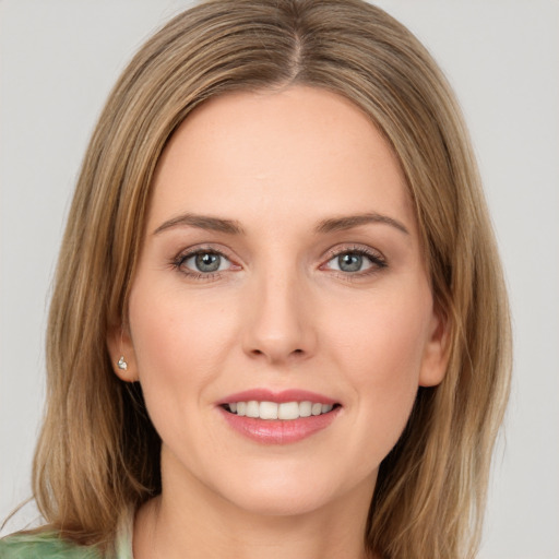 Joyful white young-adult female with medium  brown hair and green eyes