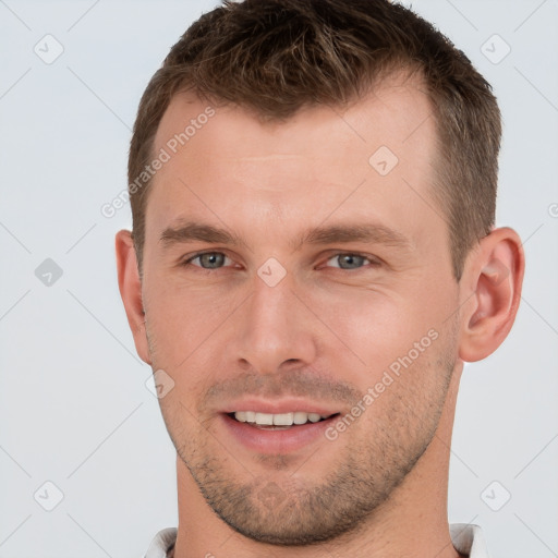 Joyful white young-adult male with short  brown hair and grey eyes