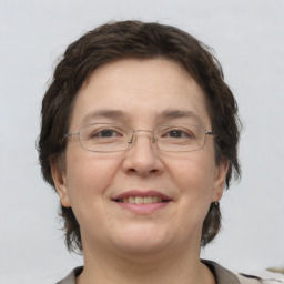 Joyful white adult female with short  brown hair and grey eyes