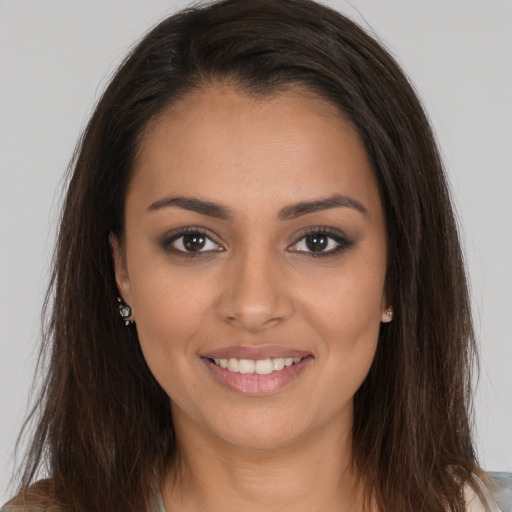 Joyful white young-adult female with long  brown hair and brown eyes