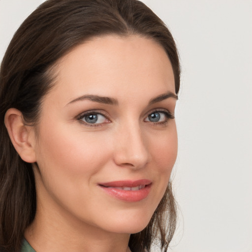 Joyful white young-adult female with long  brown hair and grey eyes