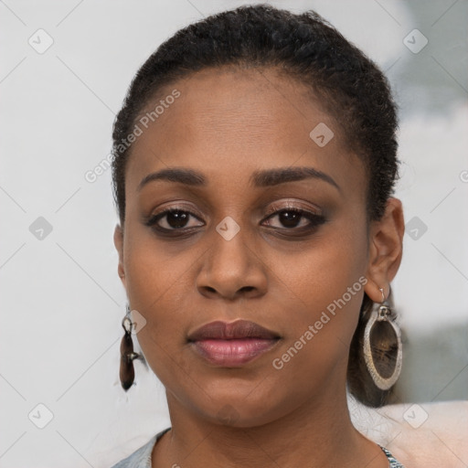 Joyful black young-adult female with short  brown hair and brown eyes