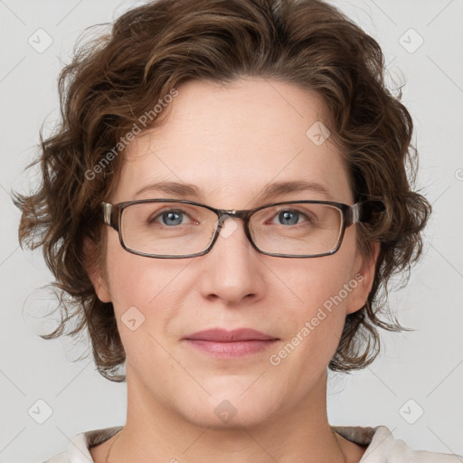 Joyful white adult female with medium  brown hair and blue eyes