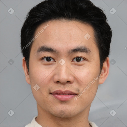 Joyful asian young-adult male with short  black hair and brown eyes