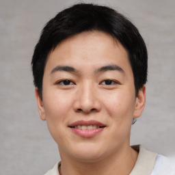 Joyful asian young-adult male with short  black hair and brown eyes