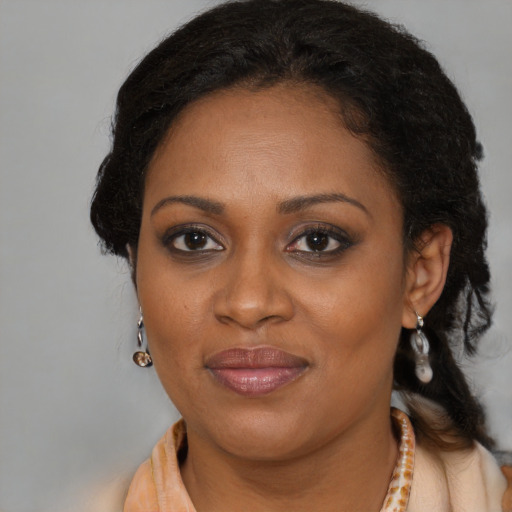 Joyful black adult female with medium  brown hair and brown eyes