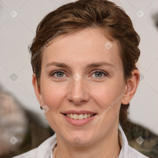 Joyful white adult female with short  brown hair and grey eyes