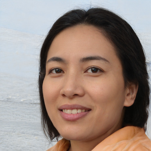 Joyful asian young-adult female with medium  brown hair and brown eyes