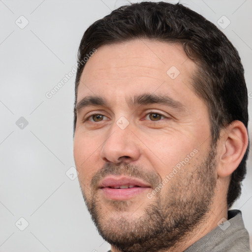 Joyful white adult male with short  black hair and brown eyes