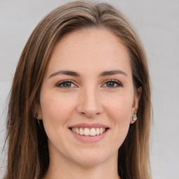 Joyful white young-adult female with long  brown hair and green eyes