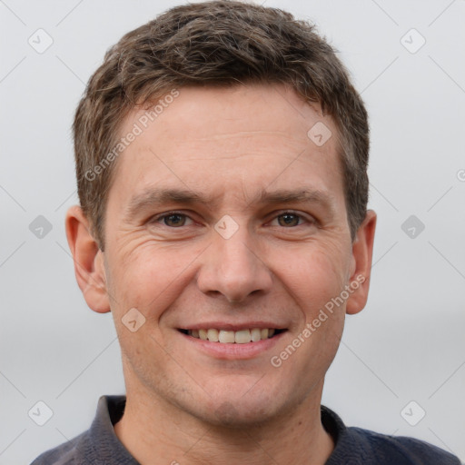 Joyful white adult male with short  brown hair and grey eyes