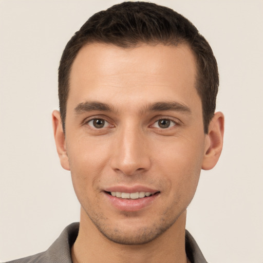 Joyful white young-adult male with short  brown hair and brown eyes