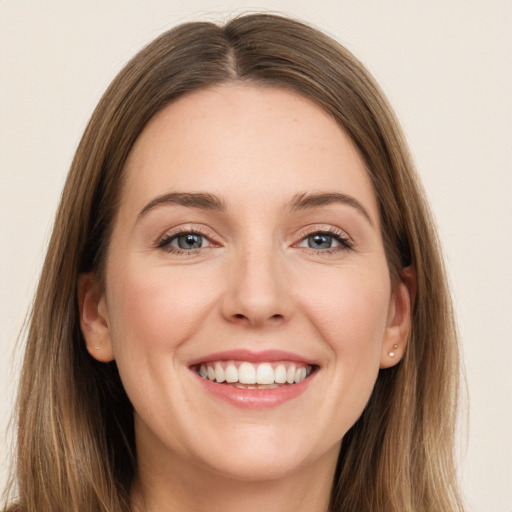 Joyful white young-adult female with long  brown hair and grey eyes